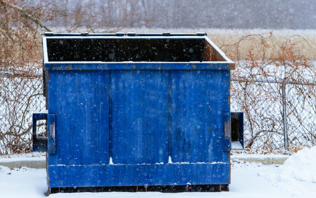 Trash bin at the side of street in winter with lip garbage container winter snow